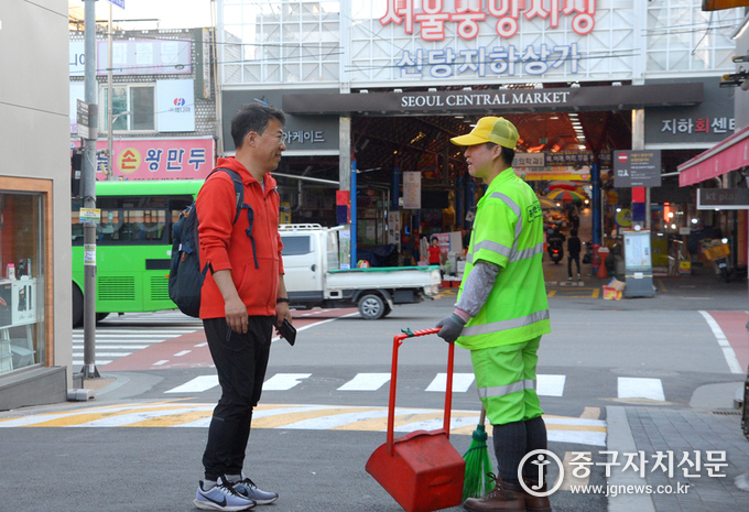 서양호 구청장이 걸어서 출근하며 만난 가로공무관과 이야기를 나누고 있다.
