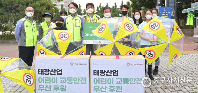태광산업에서 충무초등학교에 어린이 교통안전 우산을 후원한 뒤 기념촬영을 하고 있다.