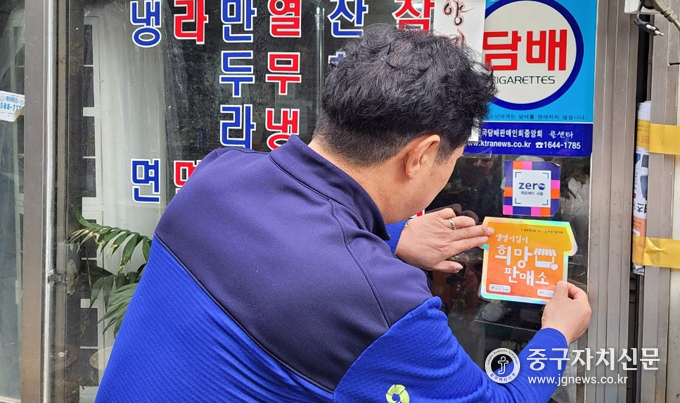 번개탄 판매업소 '희망판매소'를 신규 발굴하고 안내 스티커를 부착하고 있다.