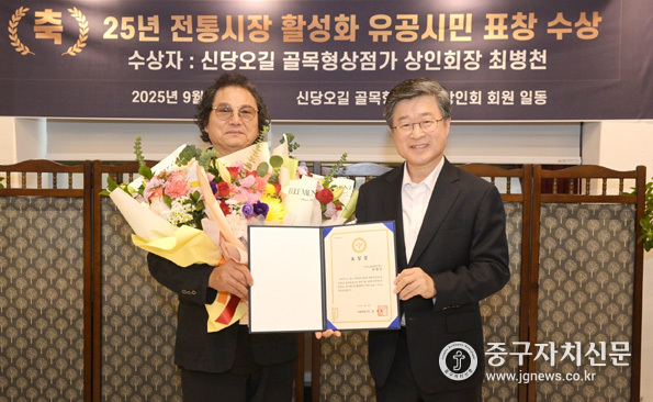 신당오길골목형상점가에 방문한 김길성 중구청장(우)이 최병천 회장에게 표창장을 전달했다.